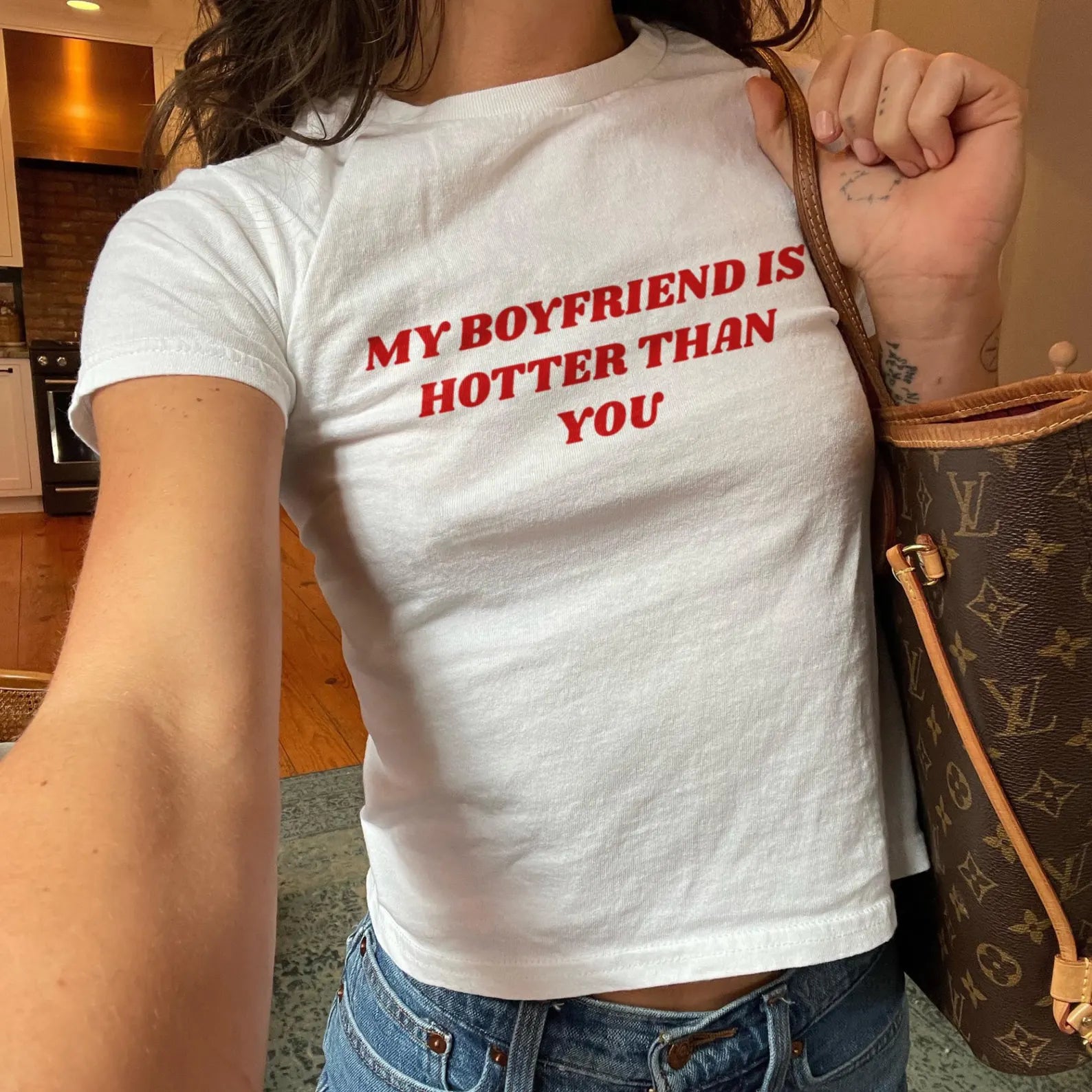 T-shirt featuring the phrase 'My Boyfriend Is Hotter Than You', perfect for making a bold fashion statement.